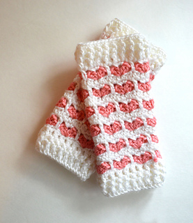 baby leg warmers made with a heart crochet stitch lying flat