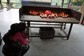 Mother and daughter looking at lotus flower shaped candles at Bailian Dong park in Zhuhai China