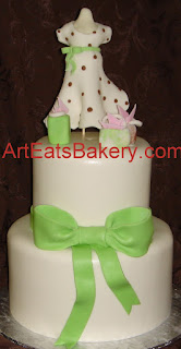 Two tier custom fondant baby shower cake with green bow, shopping bags, expecting mom maniquin with polka dot dress