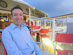 The Sunset Bar in the background while Larry smiles happily The Sunset Bar in the background while Larry smiles happily