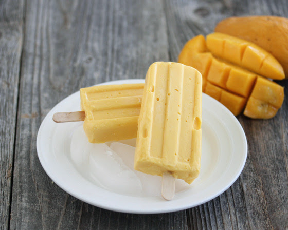 two Creamy Mango Ice Pops on white plate
