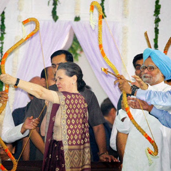 UPA Chairperson Sonia Gandhi and Prime Minister Manmohan Singh try their hands on Bow and Arrow during Dussehra celebrations at Ram Leela Maidan in New Delhi on Sunday.
