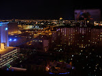 Looking up at the Flamingo at night with cool silhouetted palm trees in place