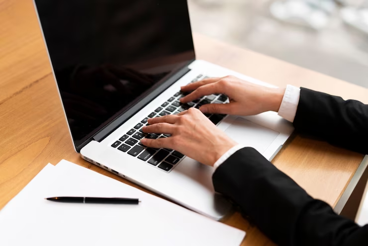 Focused candidate typing on a laptop.