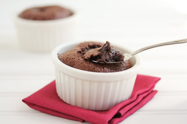 photo of a spoon dipping into a ramekin of chocolate pudding