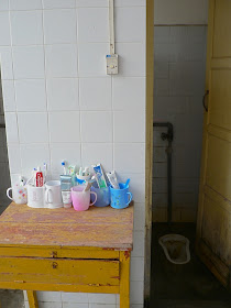 bathroom with squat toilet in dorm room at the Guangxi Normal University for Nationalities in Longzhou, China