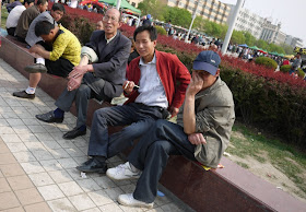 three men sitting at Nanmen Square in Yinchuan, Ningxia, China