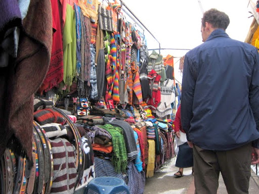 Jack walking among the hundreds of merchandise in Otavalo market, Ecuador
