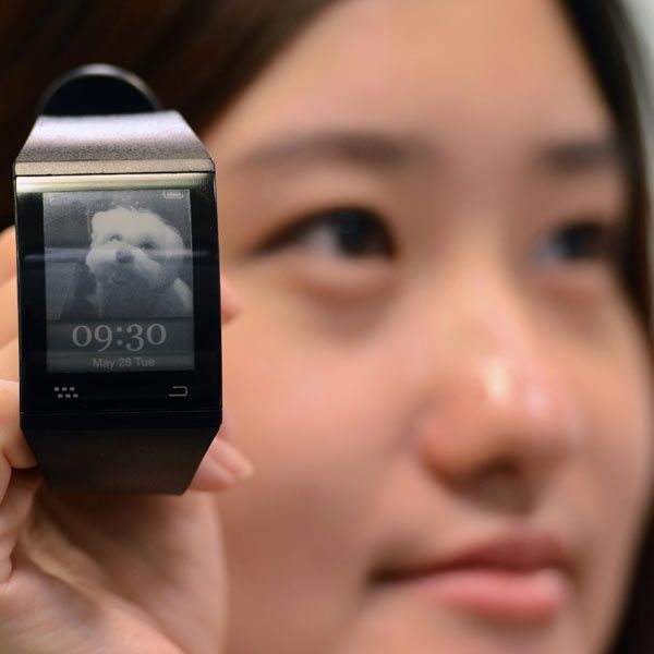 A woman displays a smart watch developed by Sonostar during Computex 2013 in Taipei, Taiwan. The device is scheduled to hit market in the third quarter, with a price tag of 179 USD.