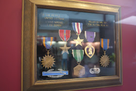 various medals with a plaque reading "To the people of a united Vietnam: I was wrong. I am sorry."