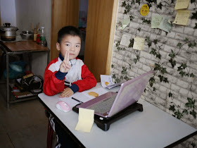 boy using a laptop at the Black Tide (黑潮) cafe