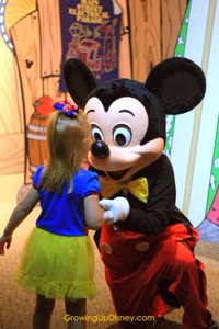Mickey Mouse in yellow bow tie, Mickey getting a kiss