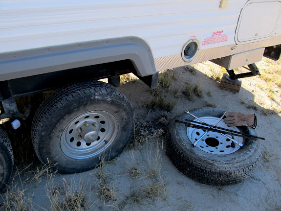 Changing a flat tire on the trailer Wednesday morning