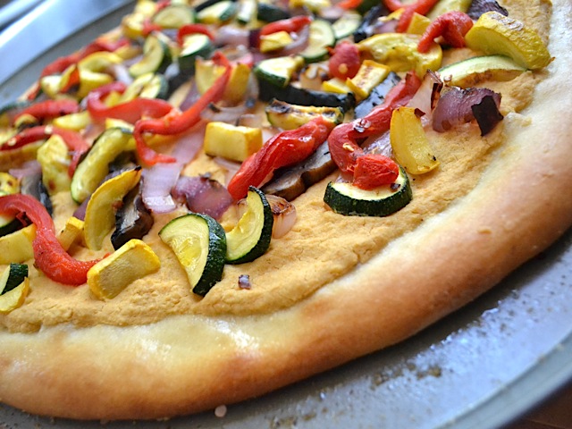 Close up of hummus grilled vegetable pizza