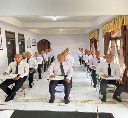 A group of men in uniform sitting in a rowDescription automatically generated