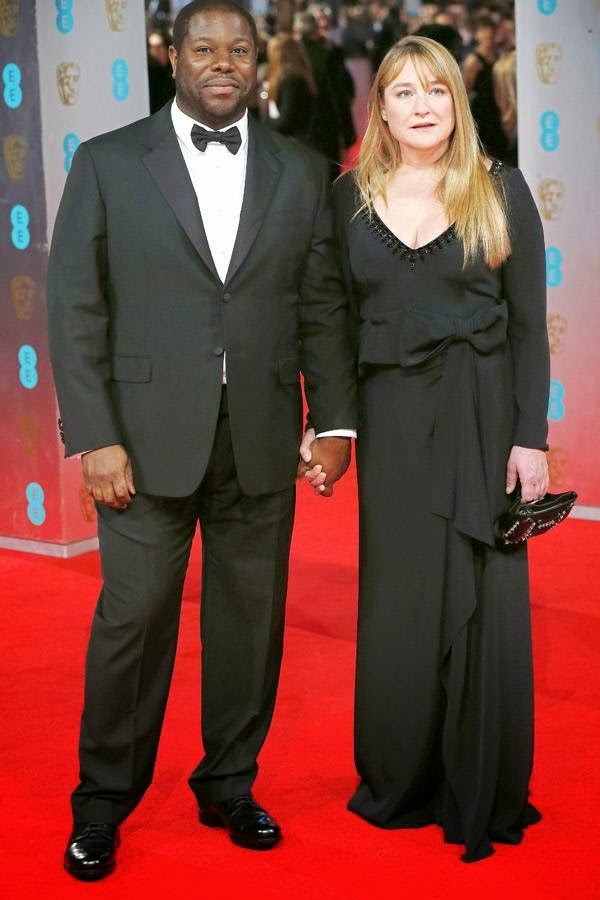 British director Steve McQueen (L) and his partner Bianca Stigter arrive on the red carpet for the BAFTA British Academy Film Awards at the Royal Opera House in London on February 16, 2014.