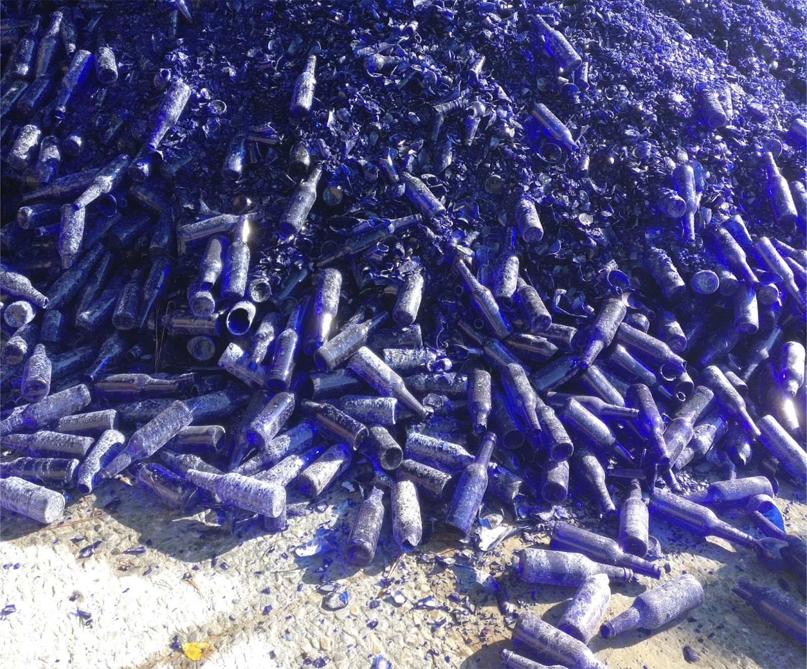 Giant pile of blue glass bottles