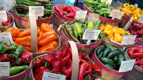 Organic Roasted Chli Peppers from Westwind Gardens, Forest Grove, OR at Portland Farmers Market PSU in autumn. The aroma of the freshly roasting peppers is incredible