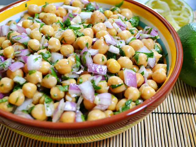 side view of a bowl of cumin lime chickpeas