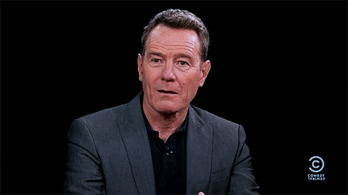 Brian Cranston pointing to himself saying "Me?"