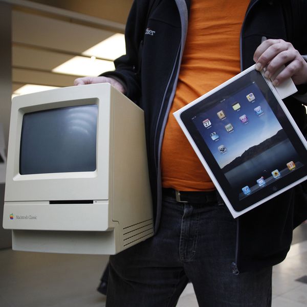 A man displays his old Apple Macintosh Classic computer from 1990 beside his newly purchased Apple iPad after being among the first to purchase the new device during an iPad launch event at the Apple retail store in Hamburg May 28, 2010.