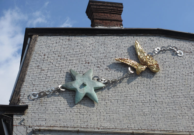 Star anchor and angel wings on a chain.