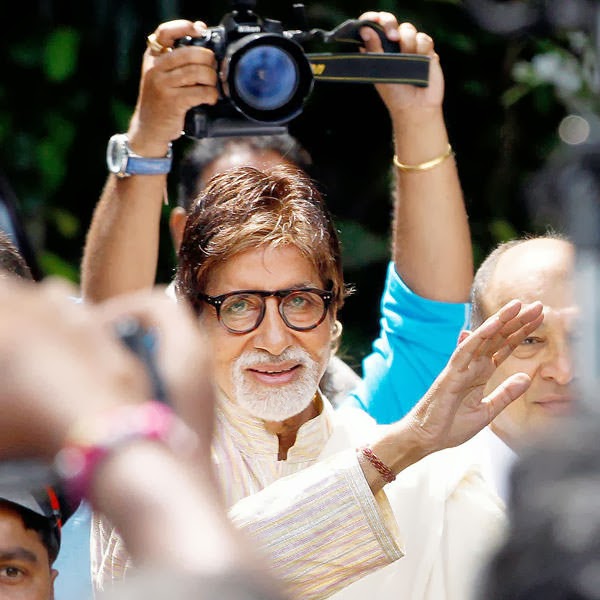 Bollywood actor Amitabh Bachchan smiles as he greet his fans outside his residence on his 71st birthday in Mumbai, India, Friday, Oct. 11, 2013. 