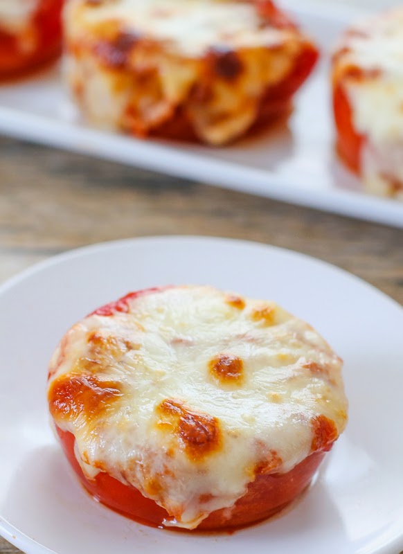 photo of one cheesy stuffed tomato on a plate