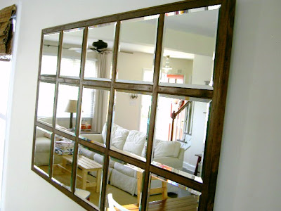 mirror reflects family room