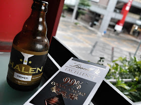 A bottle of Halen Tripel 9% alcohol beer and a bar of Lindt 99% cocoa chocolate
