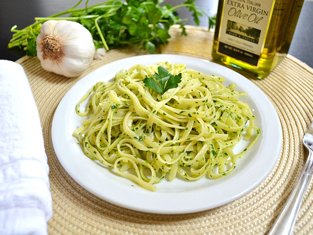 Plate of Parsley Pesto Pasta with ingredients on side to stage photo 