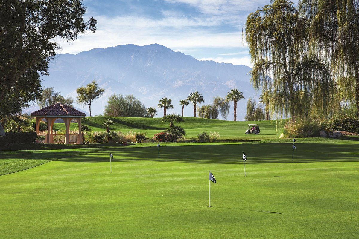 A scenic golf course with mountain ranges in the back