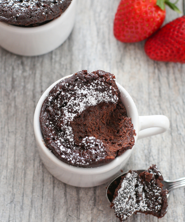 overhead close-up shot of a chocolate mug cake with a scoop taken out