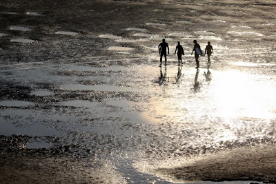 Surfers on the beach in Cornwall in the UK