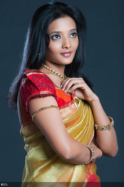 Koshri poses in traditionals during a photoshoot.