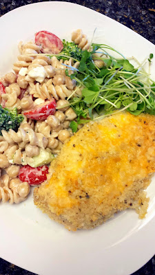 Cheddar Garlic Oven Baked Chicken Breast with gluten free pasta with cherry tomatoes and broccoli and microgreens and a touch of feta