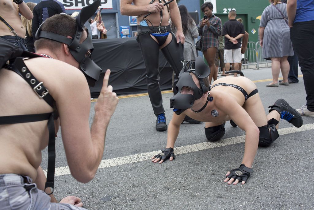 Two men dressed as dogs role play in the street during the Folsom Street Fair in San Francisco, Calif. on September 21, 2014. Photo: Ian C. Bates, Special To The Chronicle