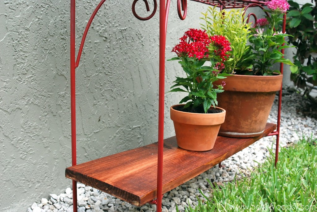 Bottom view of a wood rack with plants resting on it.