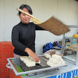 Grilling sticky rice cakes in Lembang, a hilly resort area outside of Bandung...
