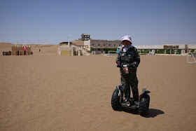 Woman riding a Segway on the sand at Shapotou in Ningxia, China