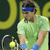 Rafael Nadal of Spain returns the ball to Philipp Kohlschreiber of Germany during the ATP Qatar Open tennis tournament in Doha January 3, 2012. REUTERS/Fadi Al-Assaad (QATAR - Tags: SPORT TENNIS)