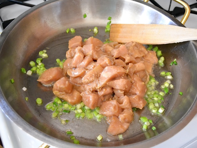 Marinated chicken added to hot pan 