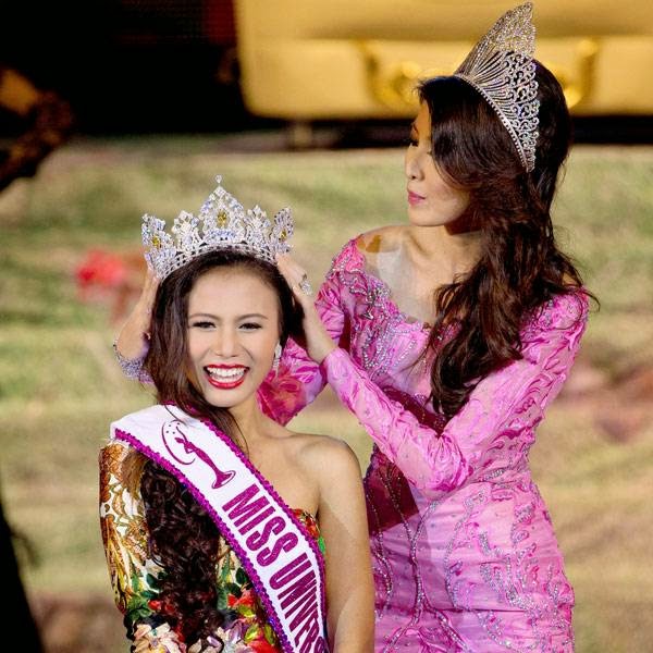 Miss Universe Myanmar 2014 Sharr Htut Eaindra, left, is crowned by Miss Universe Myanmar 2013 Moe Set Wine, right, during a pageant in Yangon, Myanmar, Saturday, July 26, 2014.
