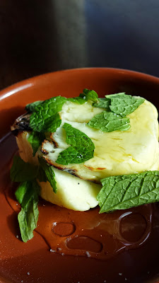Cafe Castagna brunch item of grilled halloumi with honey, here with some torn basil
