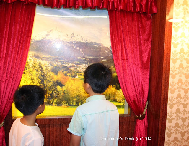 The boys at the moving train windows inside the castle. 