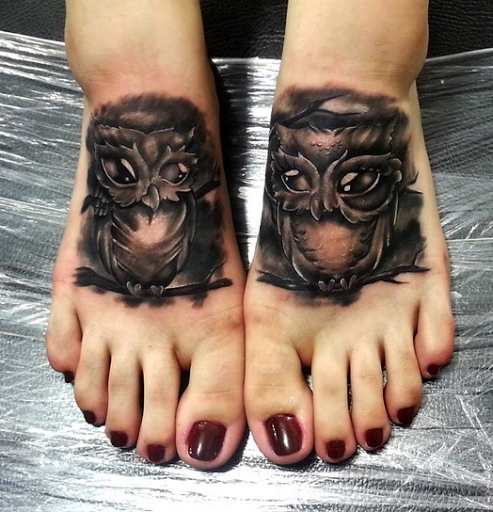 Two matching black inks using owl tattoo on his feet