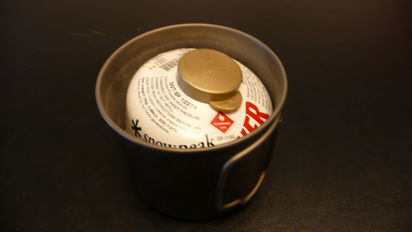 A MicroRocket and a canister of gas in a small mug type pot