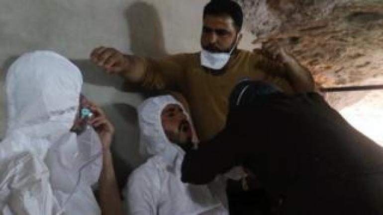 A man breathes through an oxygen mask in Khan Sheikhoun