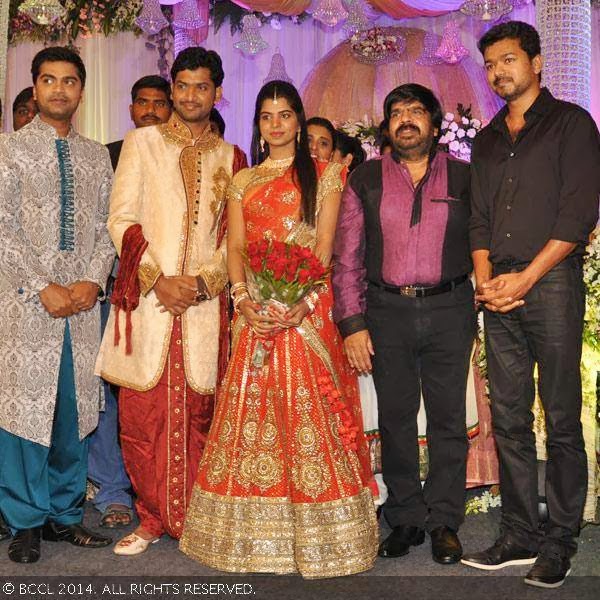 Abhilash and Elakkiya pose onstage with Simbu, T Rajendar and Vijay during their wedding reception party, held at The Leela Palace in Chennai.