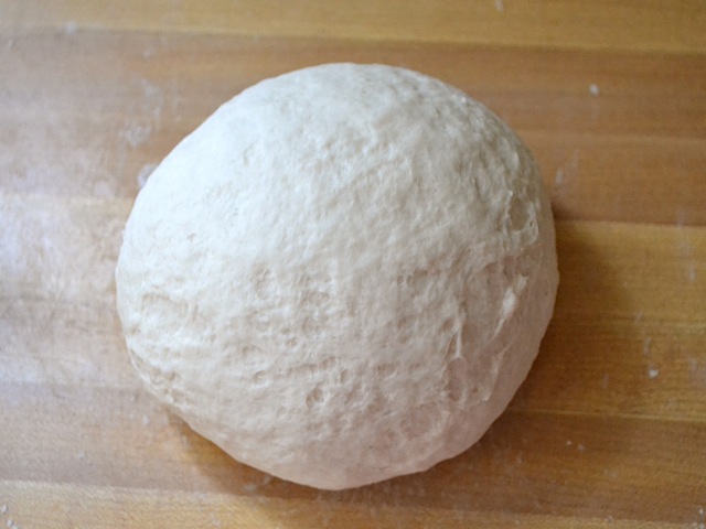 dough ball on floured surface 
